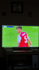 Person watches PSG-Arsenal soccer match on TV in Burgas