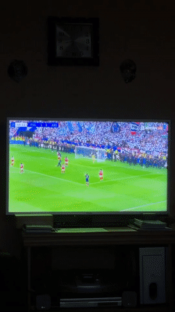 Person watches PSG-Arsenal soccer match on TV in Burgas