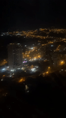 Nighttime aerial view captures illuminated La Paz cityscape