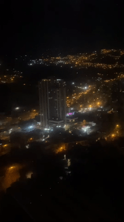 Nighttime aerial view captures illuminated La Paz cityscape