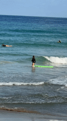Surfers hit the Tel Aviv waves on a sunny summer morning