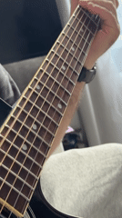Person plays acoustic guitar in Moscow apartment