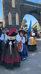 Traditional dress and a stone archway in Ables, Spain