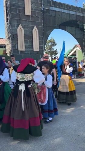 Traditional dress and a stone archway in Ables, Spain