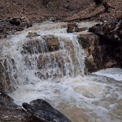 Multi-tiered waterfall flows rapidly through rock formation in Medven