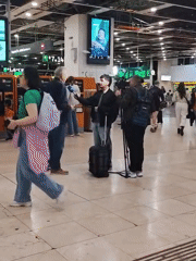 News crew interviews elderly man at Barcelona airport