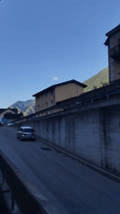 Morning scenes captured in Alpine town with trains, buildings