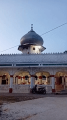 White-domed mosque with red accents in Lhokseumawe, Aceh