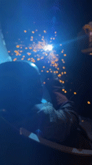 Welding a metal structure in a dark industrial space, Montenegro