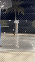 Man plays basketball at night in Altea, Spain