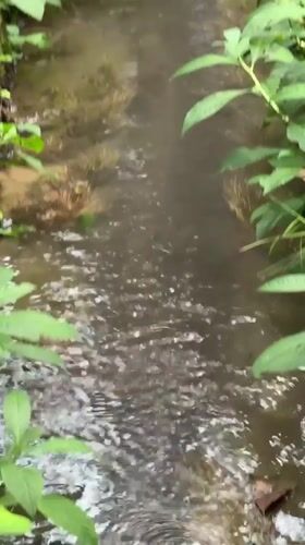 Stream flows through concrete channel in Mengwi, Indonesia
