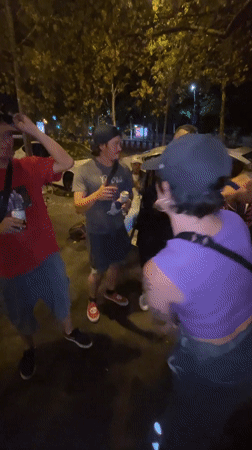 Young adults gather for nighttime street socializing in Barcelona