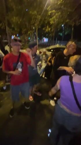 Young adults gather for nighttime street socializing in Barcelona