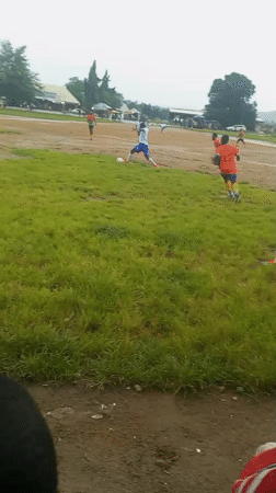 Pickup soccer on a muddy field, overcast afternoon