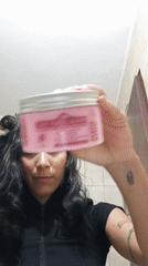 Woman documents skincare routine with pets nearby in Porlamar