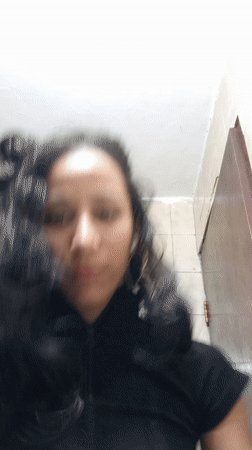 Woman documents skincare routine with pets nearby in Porlamar