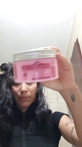 Woman documents skincare routine with pets nearby in Porlamar