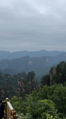 Tourist photographs scenic overlooks in Wulingyuan mountains