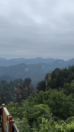 Tourist photographs scenic overlooks in Wulingyuan mountains