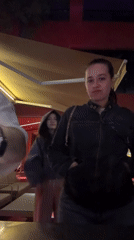Three people gather outside Yerevan bar at night
