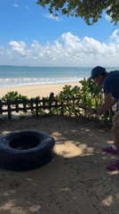 Early morning maintenance work and beach activity in Kuta Selatan