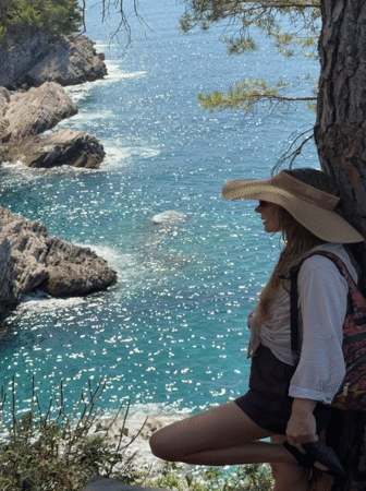 Pausing at a cliff-side tree above the Adriatic in Montenegro
