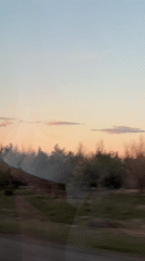 Rural landscape captured from moving vehicle in Часовенная, Russia