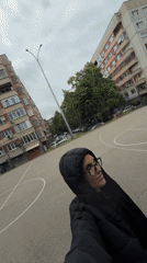 Woman films outdoor activities on basketball court in Pleven