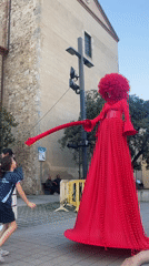 Red-costumed street performers entertain crowds in Calella, Spain