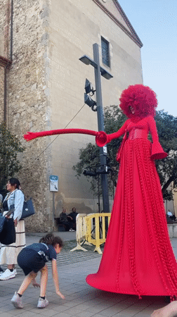 Red-costumed street performers entertain crowds in Calella, Spain
