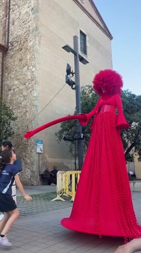 Red-costumed street performers entertain crowds in Calella, Spain