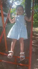 Playtime on a tire swing set in Obrochishte, Bulgaria