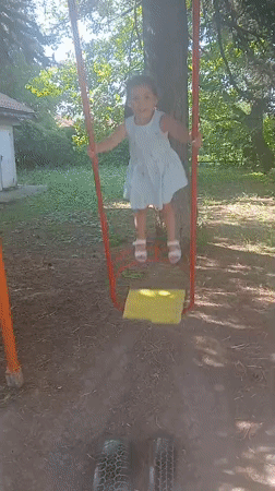 Playtime on a tire swing set in Obrochishte, Bulgaria