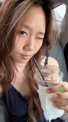 Woman observed in passenger seat holding cup in Yuzhong District