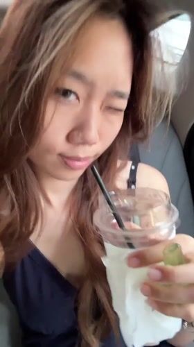 Woman observed in passenger seat holding cup in Yuzhong District
