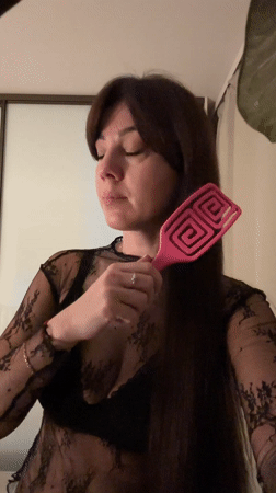 Woman takes mirror selfie in Riga wearing Bordeaux shirt