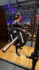 Man performs barbell curls at Murino gym