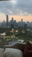 Hotel guest records Bangkok skyline views during dusk hours