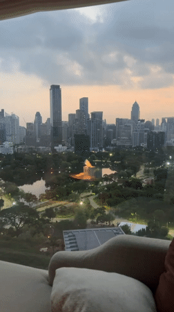Hotel guest records Bangkok skyline views during dusk hours