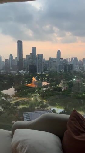 Hotel guest records Bangkok skyline views during dusk hours
