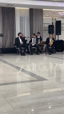 Live band and berry cake at a Moldovan indoor celebration