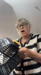 Woman observed in kitchen with colander in Chambœuf, France