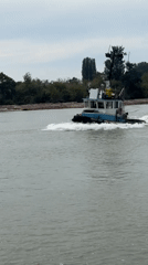 Tugboat, yacht, and catamaran ferry share calm Vancouver waters