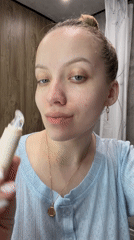 Woman documents evening skincare routine in Russian bathroom