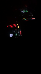 DJ equipment and dashboard lights captured in dark Tel Aviv interior