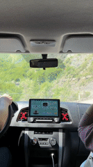 Two people drive mountain road in documented journey