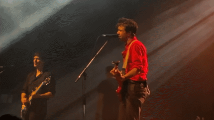 Live band performance captured on stage in Milan