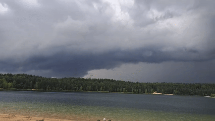 Summer morning at Lytkarino quarry lake, storm clouds rolling in