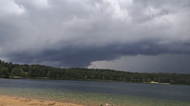 Summer morning at Lytkarino quarry lake, storm clouds rolling in