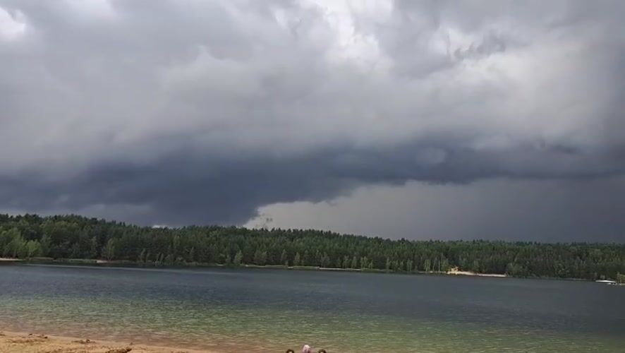 Summer morning at Lytkarino quarry lake, storm clouds rolling in